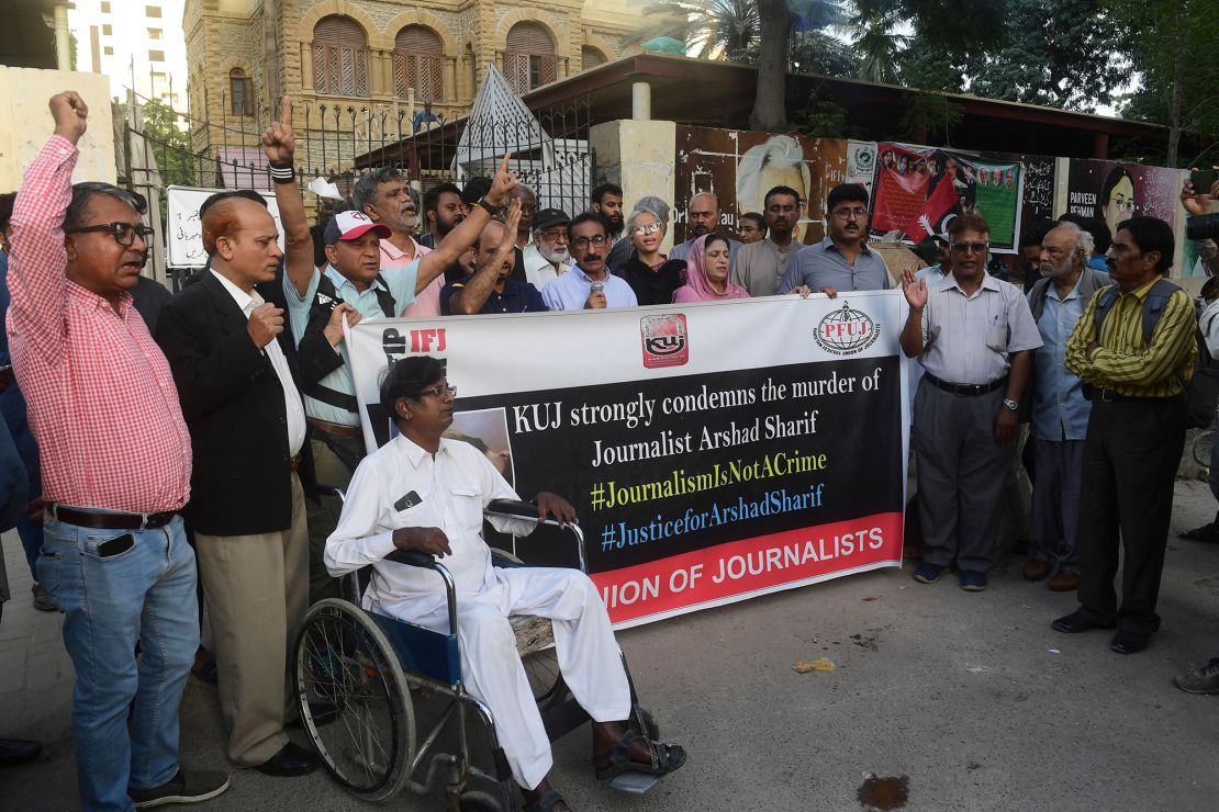 Media representatives shout slogans during a protest in Karachi on October 24, 2022.
