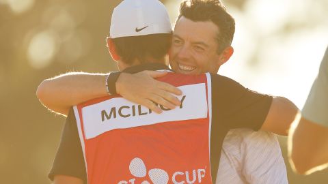 McIlroy embraces caddy Harry Diamond after his victory.