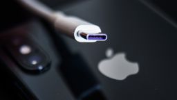 USB-C cable and Apple logo on iPhone are seen in this illustration photo taken in Krakow, Poland on September 25, 2021.