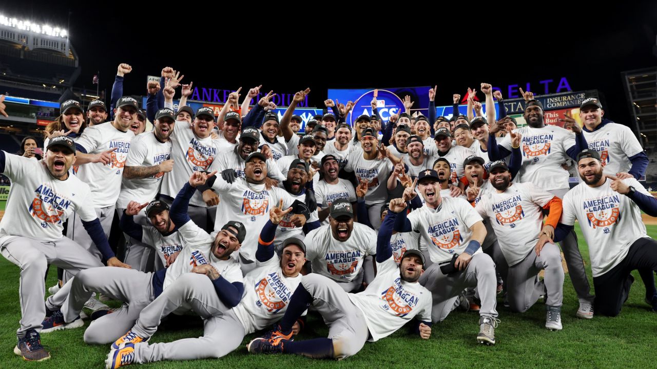 Members of the Houston Astros pose for a photo on the field after defeating the New York Yankees at Yankee Stadium on Sunday, October 23, 2022.