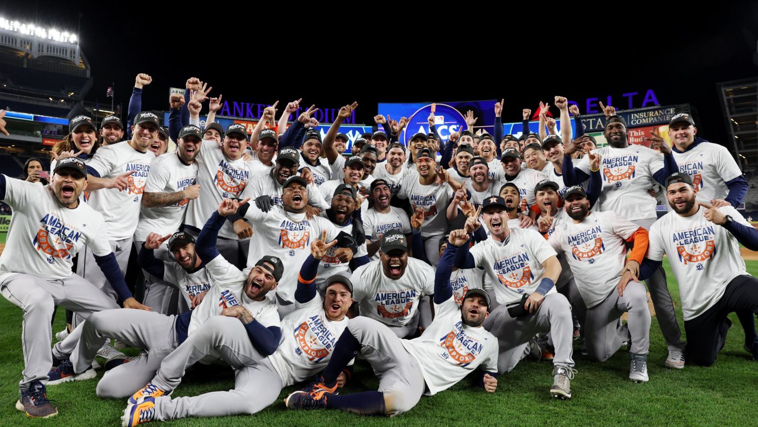 Members of the Houston Astros pose for a photo on the field after defeating the New York Yankees at Yankee Stadium on Sunday, October 23, 2022.