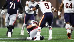 FOXBOROUGH, MA - OCTOBER 24: Mac Jones #10 of the New England Patriots slides and kicks Jaquan Brisker #9 of the Chicago Bears during the second quarter of an NFL football game at Gillette Stadium on October 24, 2022 in Foxborough, Massachusetts. (Photo by Kevin Sabitus/Getty Images)
