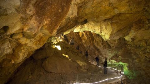 Visitors come down a trail during a guided tour on June 14, 2016, at the Grand Canyon Caverns in Peach Springs, Arizona. Five people have been trapped below the surface at the tourist attraction since Sunday, officials say.