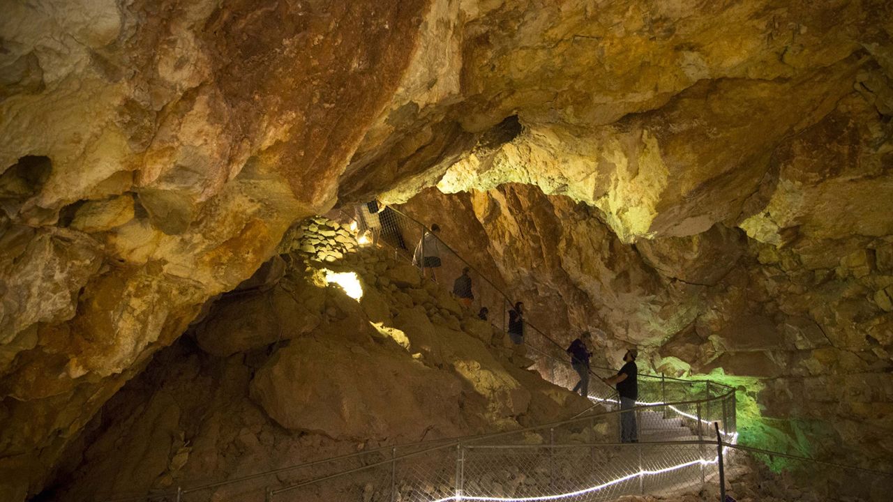 Visitors come down a trail during a guided tour on June 14, 2016, at the Grand Canyon Caverns in Peach Springs, Arizona. Six people have been trapped below the surface at the tourist attraction since Sunday, officials say.