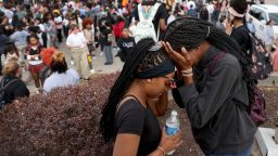 Students stand in a parking lot near the Central Visual & Performing Arts High School after a  shooting at the school in St. Louis on Monday, Oct. 24, 2022.