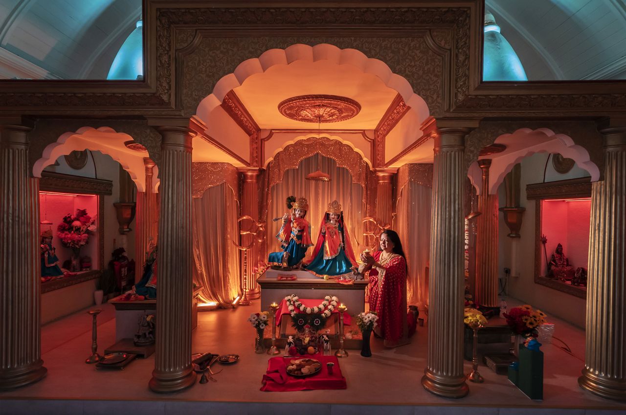 A woman prays at the Veda Mandir Hindu temple in Bolton, England.