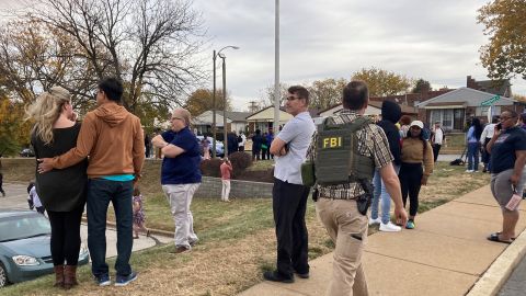 People gather Monday after a shooting at a high school in St. Louis. 