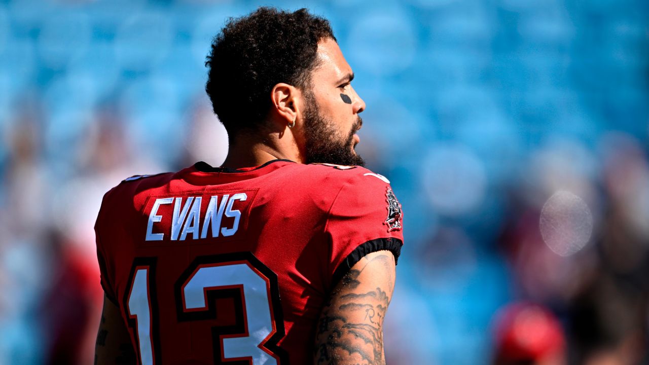 Evans walks onto the field during warm ups prior to the game against the Carolina Panthers.