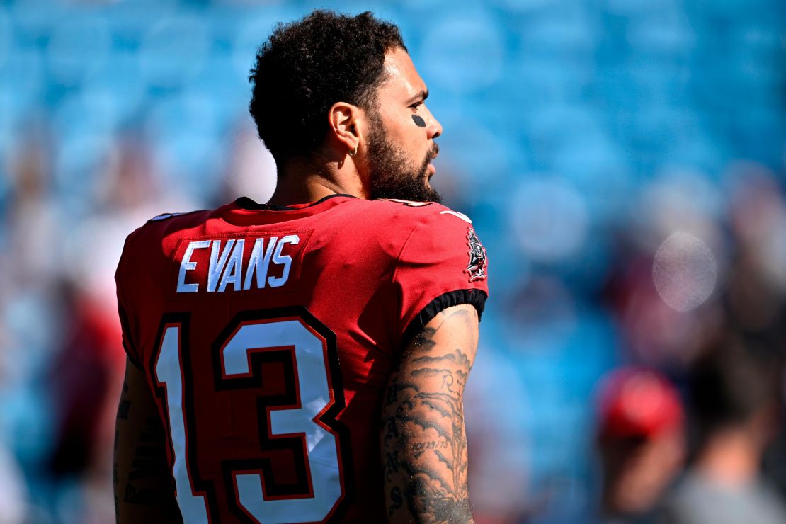 Evans walks onto the field during warm ups prior to the game against the Carolina Panthers.