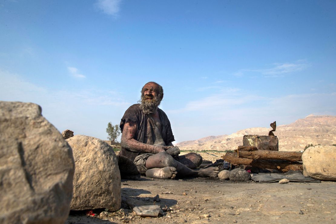 Amu Haji sits on the ground on the outskirts of the village of Dezhgah in the southwestern Iranian Fars province, on December 28, 2018. 