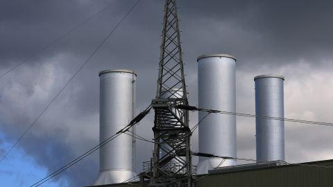 An electricity tower next to chimneys at a natural gas power plant in Brandenburg, Germany. A new UN report shows the world is still over-investing in fossil fuels as global temperatures rise. 