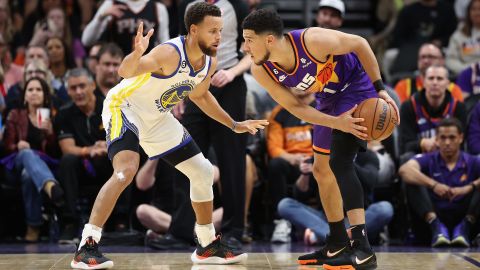 Booker handles the ball against Curry during the first half of the game in Phoenix on October 25.
