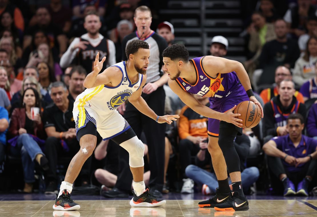 Booker handles the ball against Curry during the first half of the game in Phoenix on October 25.