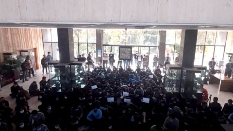 Protesters chant at a vigil for Mahsa Amini, the woman who died in police custody last month, at the entrance hall of the Khajeh Nasir Toosi University of Technology in Tehran, Iran, in this screengrab from social media video released October 26, 2022 and obtained by Reuters.  