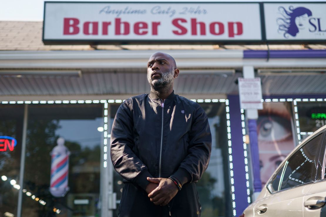 Aaron Bethea poses for a portrait outside Anytime Cutz barbershop in Atlanta.