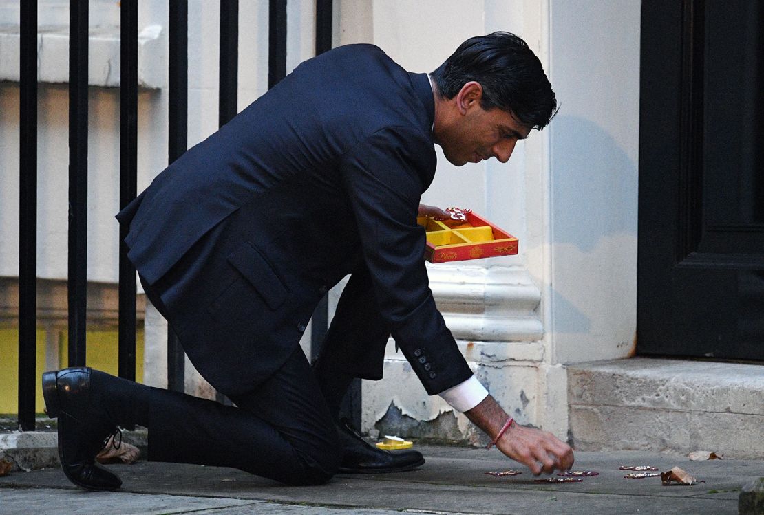 Chancellor Rishi Sunak lights a candle for Diwali in Downing Street on November 12, 2020 in London.