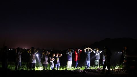 Migrants are detained by U.S. Border Patrol agents on May 22 in Yuma, Arizona. 