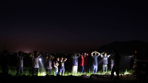 Migrants are detained by U.S. Border Patrol agents on May 22 in Yuma, Arizona.