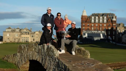 Fox poses with the Alfred Dunhill Links Championship trophy with mother Adele Fox, father Grant Fox, wife Anneke Fox and daughter Isabel Fox at Swilcan Bridge in St.  Andrews.