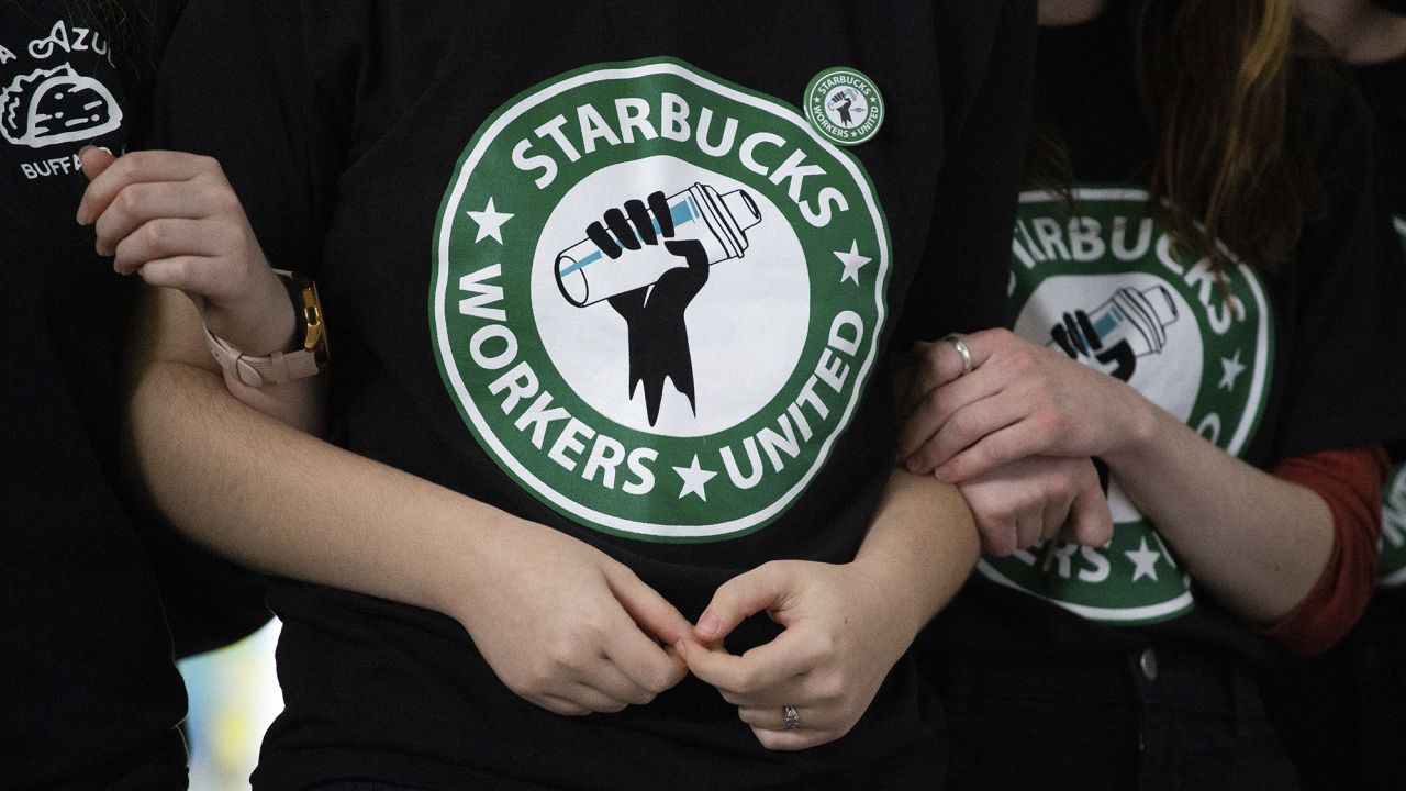 Starbucks employees and supporters react as votes are read during a union-election watch party in Buffalo, New York.  