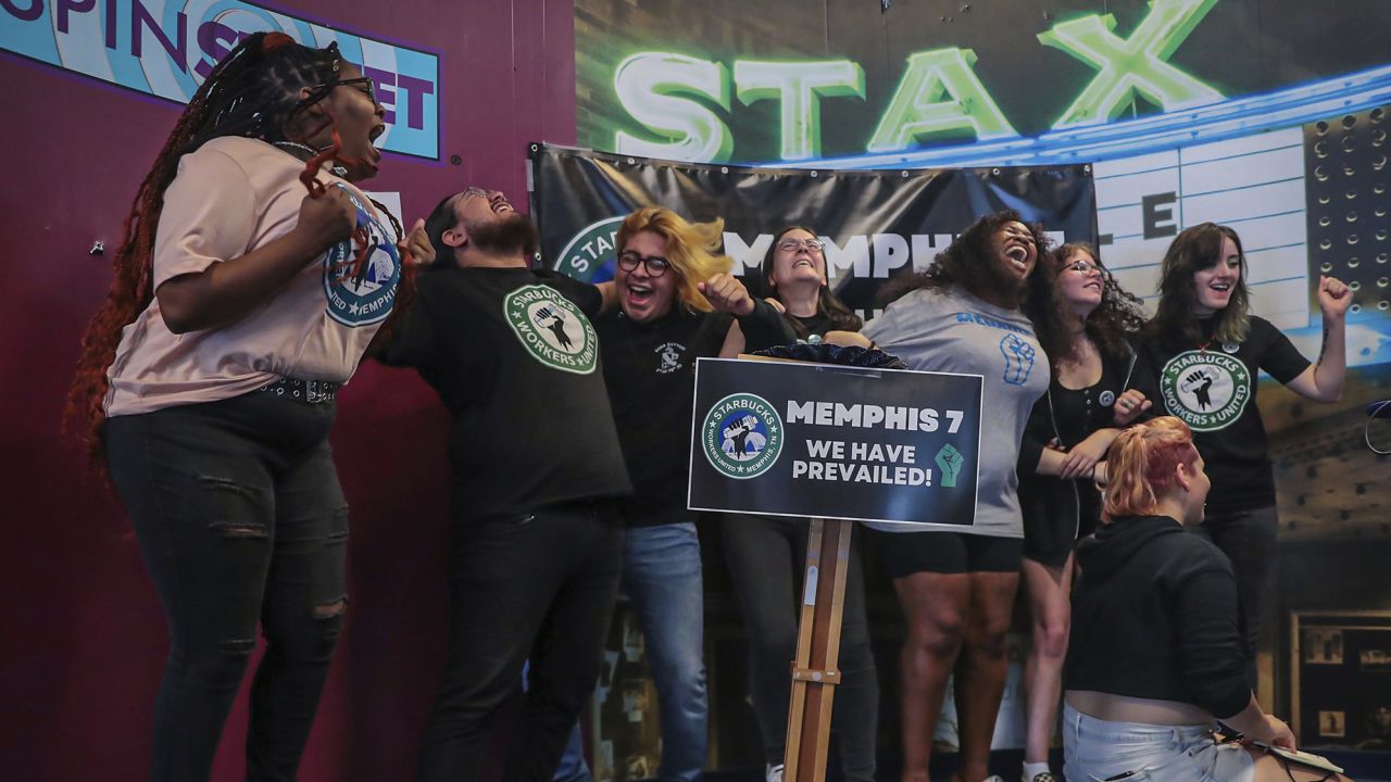 Members of the Memphis Seven, including Nabretta Hardin (far left) celebrate a vote to unionize their local Starbucks location in Memphis.
