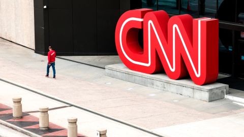 People walk by the world headquarters for CNN on March 15, 2022 in Atlanta, Georgia.