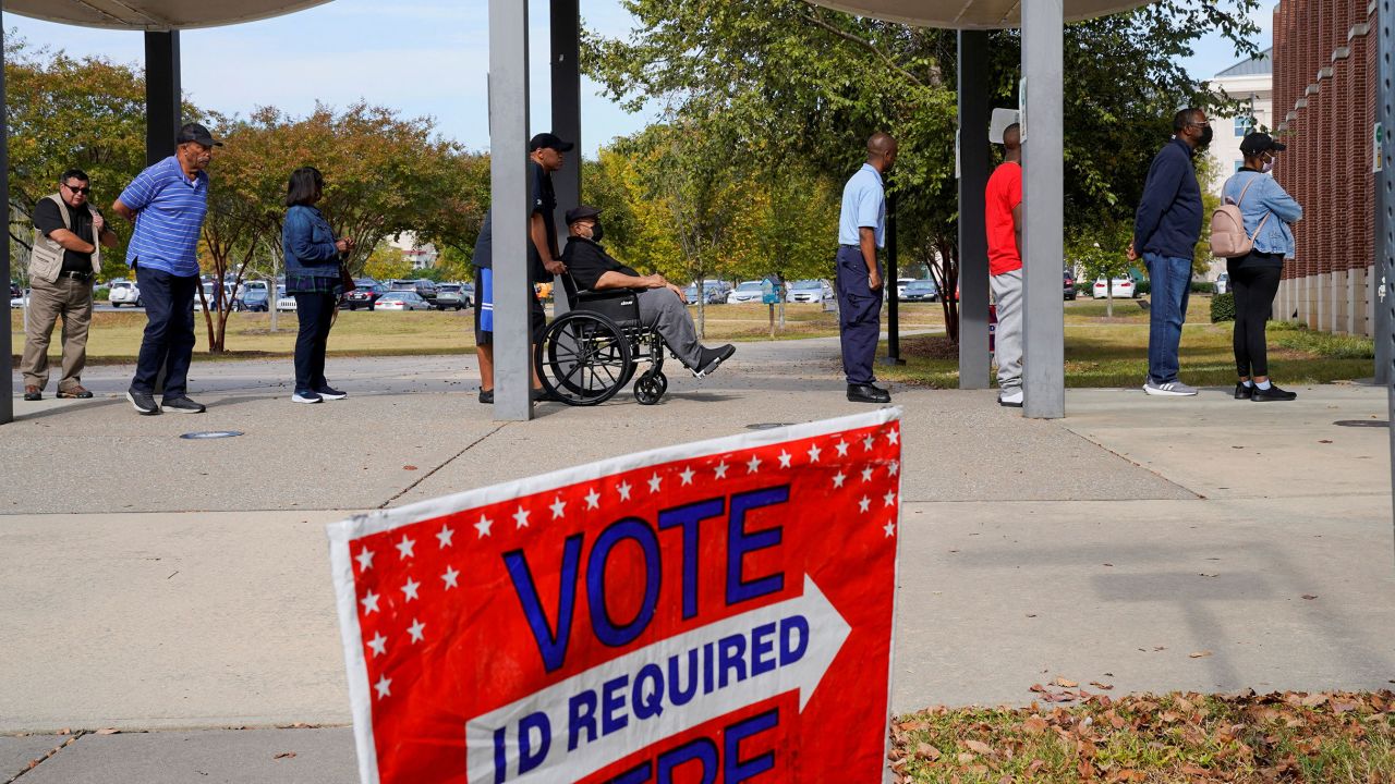 A line of early voters stretches outside the building as early voting begins for the midterm elections at the Citizens Service Center in Columbus, Georgia, U.S., October 17, 2022.  