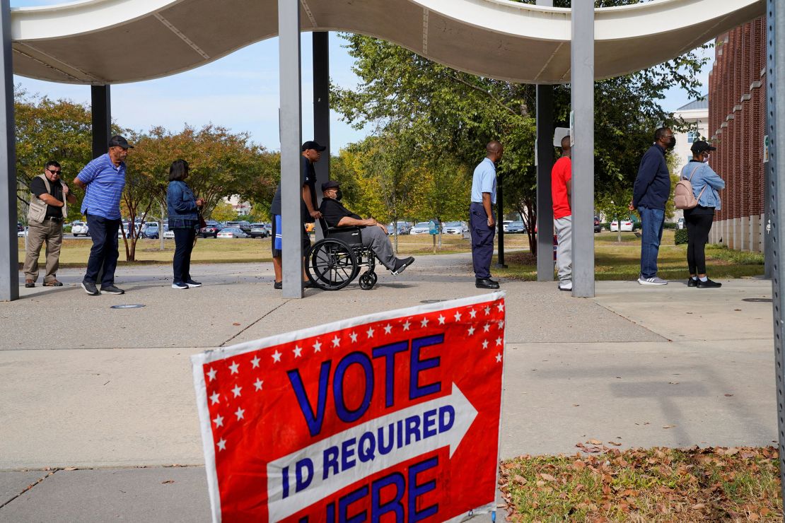 A line of early voters stretches outside the building as early voting begins for the midterm elections at the Citizens Service Center in Columbus, Georgia, U.S., October 17, 2022.  