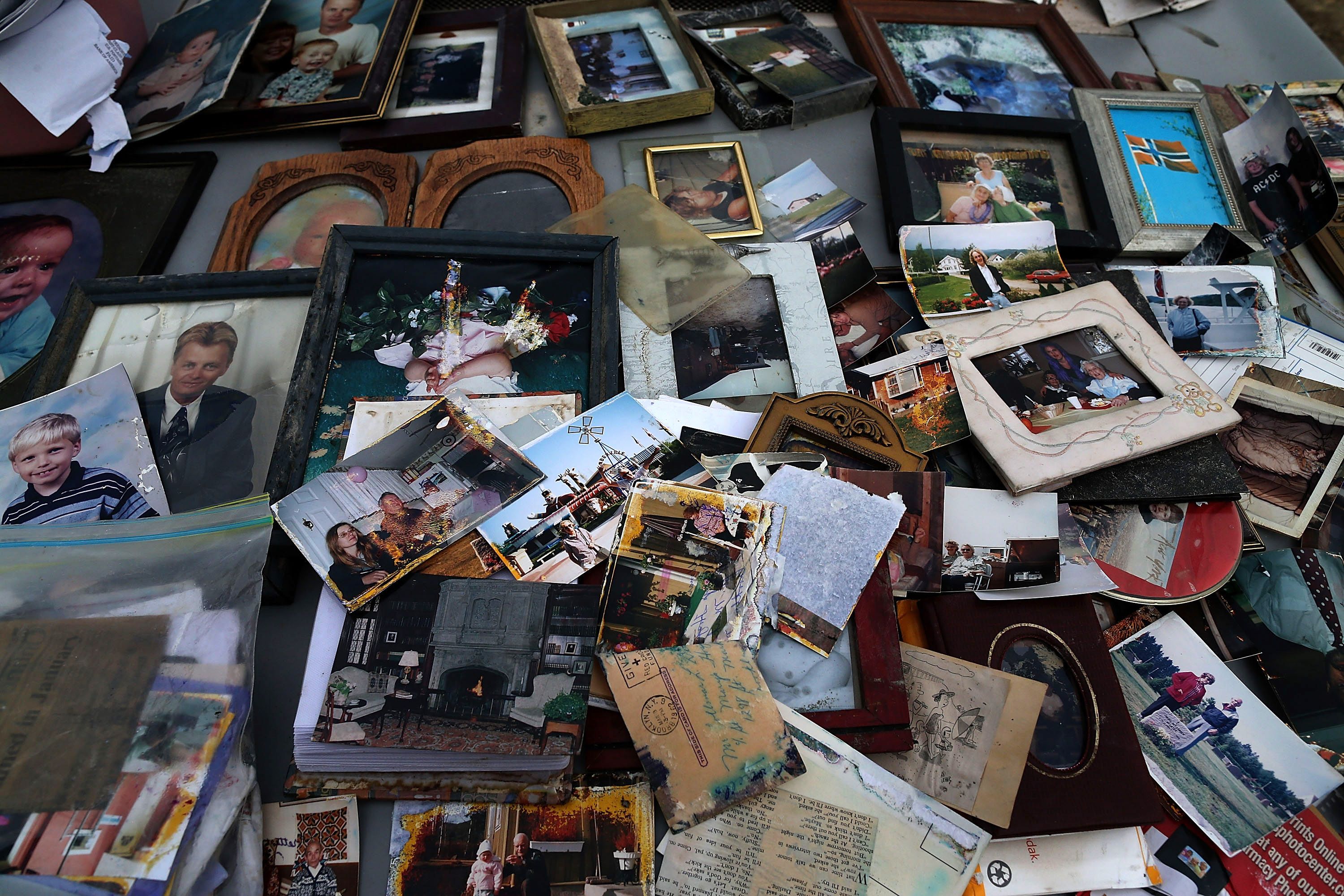 After being removed from a flooded home in Seaside Heights, old photographs are laid out on the hood of a car to dry on November 25, 2012.