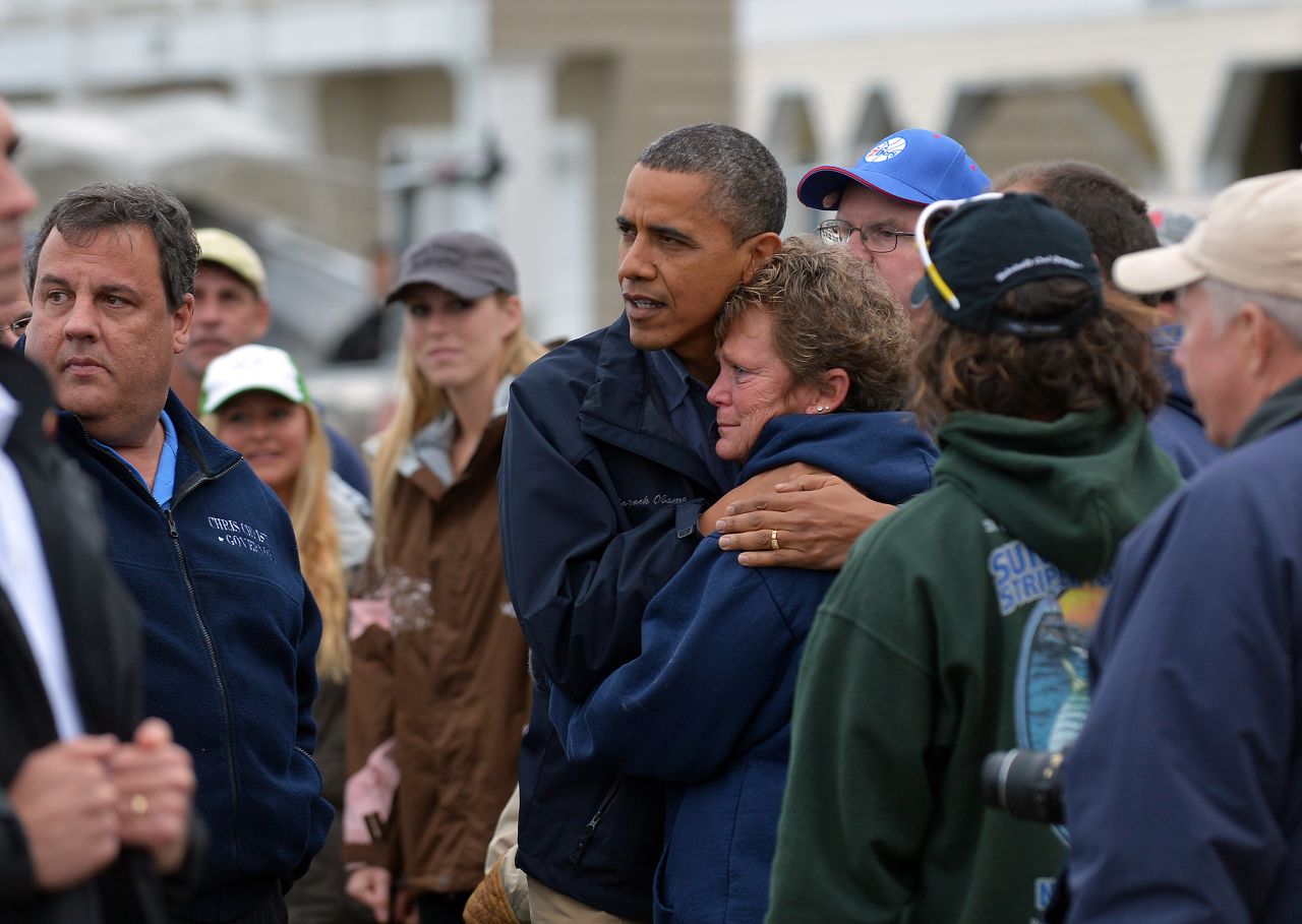 President Barack Obama and New Jersey Gov. Chris Christie comfort victims while visiting a neighborhood in Brigantine, New Jersey, on October 31, 2012.