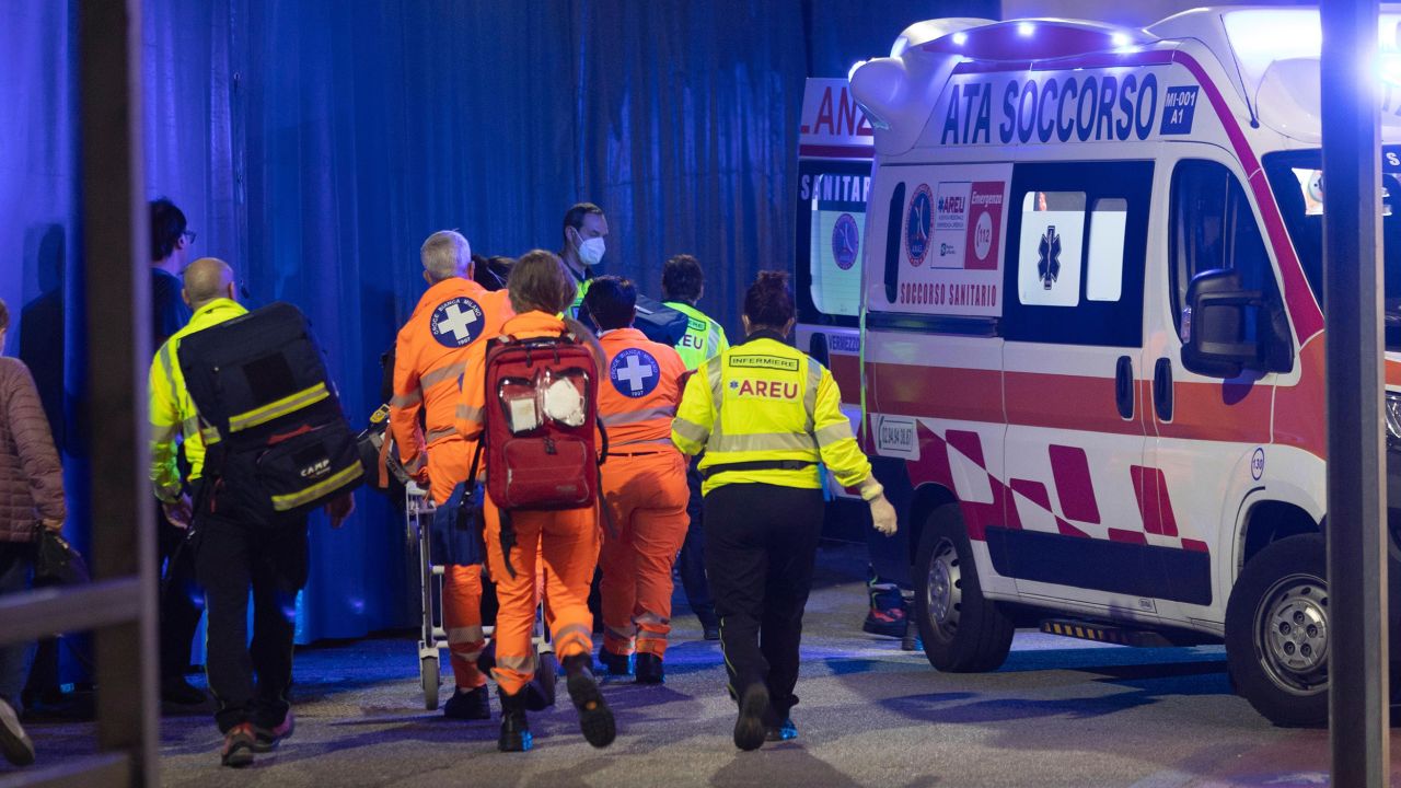 Medics wheel an injured person into an ambulance at the scene of an attack in Milan, Italy, Thursday Oct. 27, 2022.