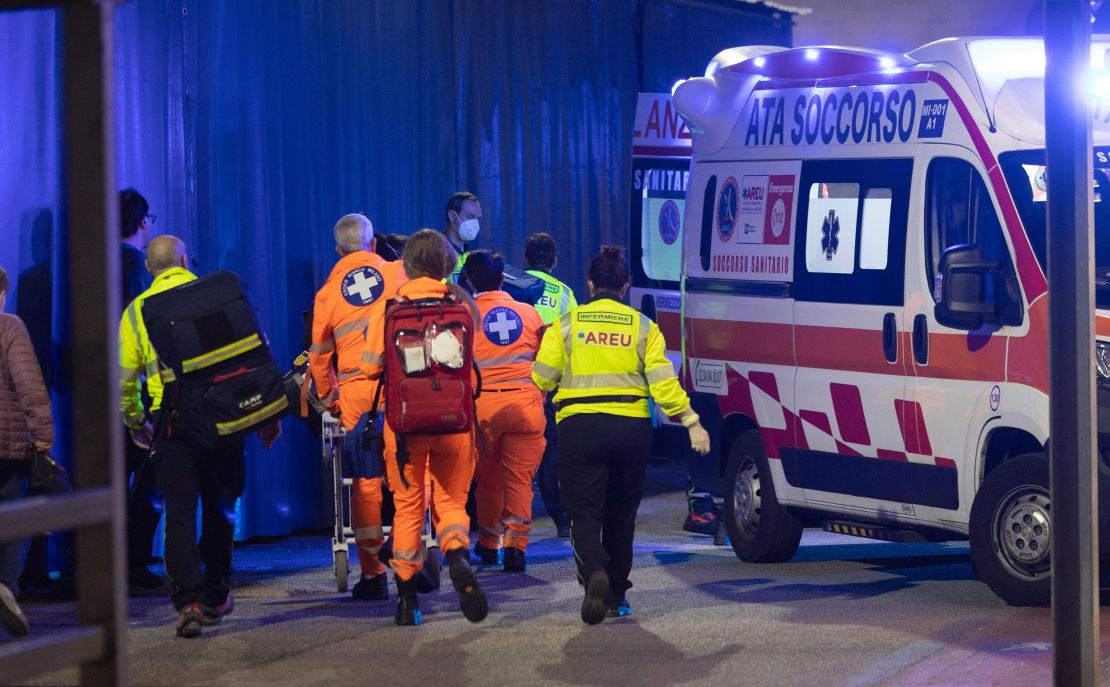 Medics wheel an injured person into an ambulance at the scene of an attack in Milan, Italy, Thursday Oct. 27, 2022.