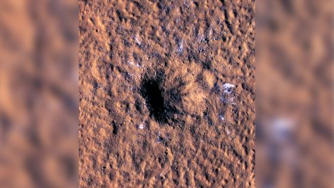 Boulder-size ice chunks can be seen scattered around and outside the new crater's rim.