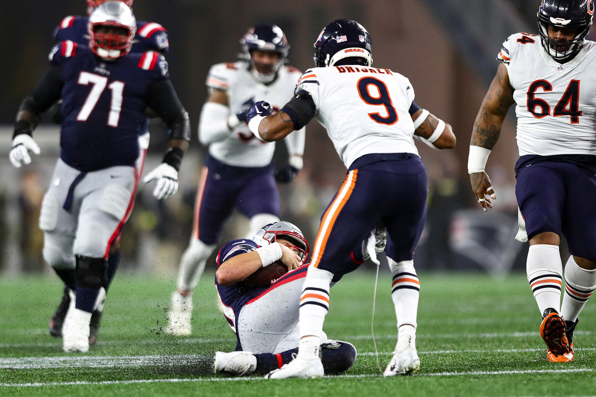 New England quarterback Mac Jones slides and accidentally kicks Chicago safety Jaquan Brisker in the groin during an NFL game in Foxborough, Massachusetts, on Monday, October 24.