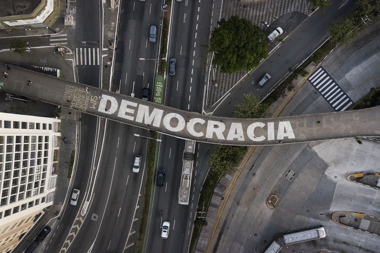 The Portuguese word for democracy is written on a pedestrian bridge in São Paulo, Brazil, on Wednesday, October 26. <a href="https://www.cnn.com/2022/10/27/americas/brazil-election-second-round-explainer-intl" target="_blank">The country's presidential runoff</a> is scheduled for Sunday.