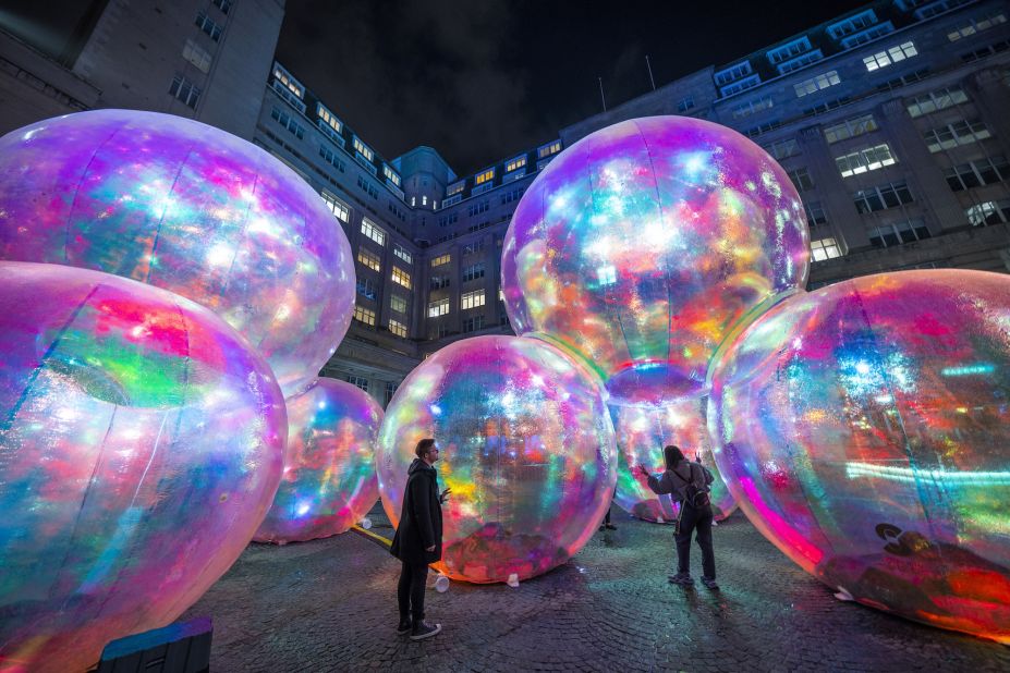People view the illuminated artwork "Evanescent," by Atelier Sisu, during the River of Light festival in Liverpool, England, on Thursday, October 20.