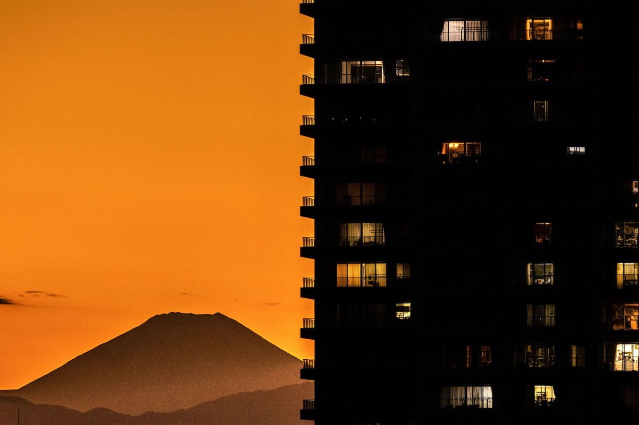 Mount Fuji, Japan's tallest mountain, is seen behind residential buildings in Tokyo on Wednesday, October 26.