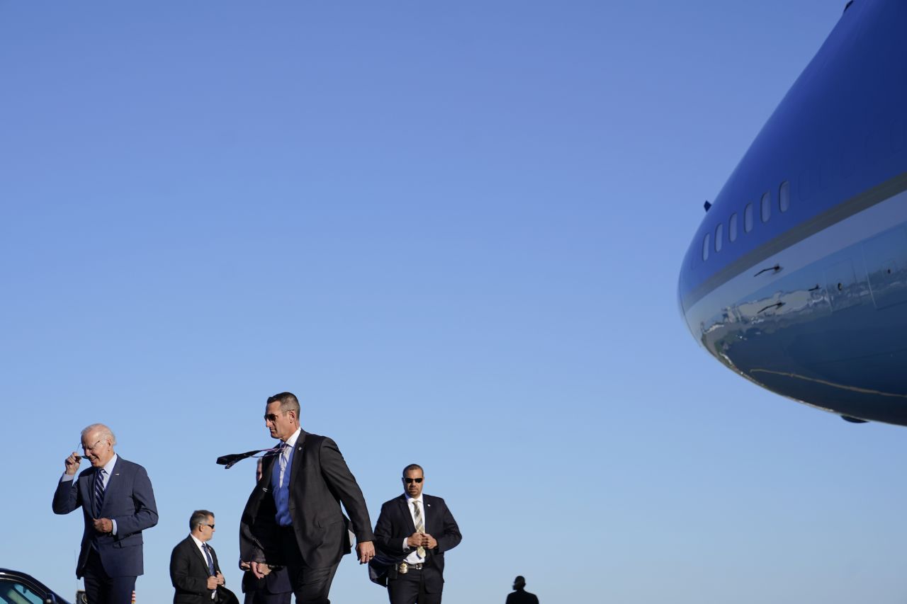 US President Joe Biden, left, and members of the Secret Service walk to their motorcade after stepping off Air Force One in Philadelphia on Thursday, October 20. Biden was heading to a reception for Senate hopeful John Fetterman.