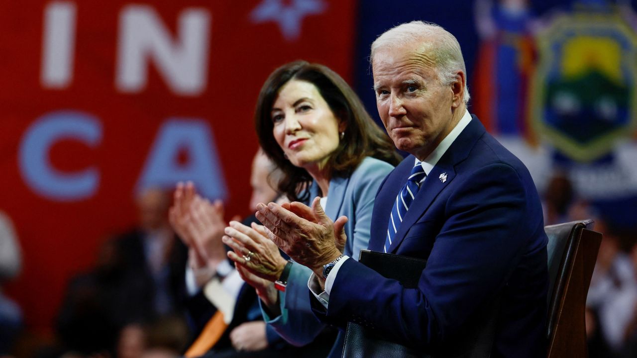 US President Joe Biden claps next to New York Governor Kathy Hochul as they attend an event on CHIPS manufacturing, at Onondaga Community College in Syracuse, New York, on October 27, 2022.