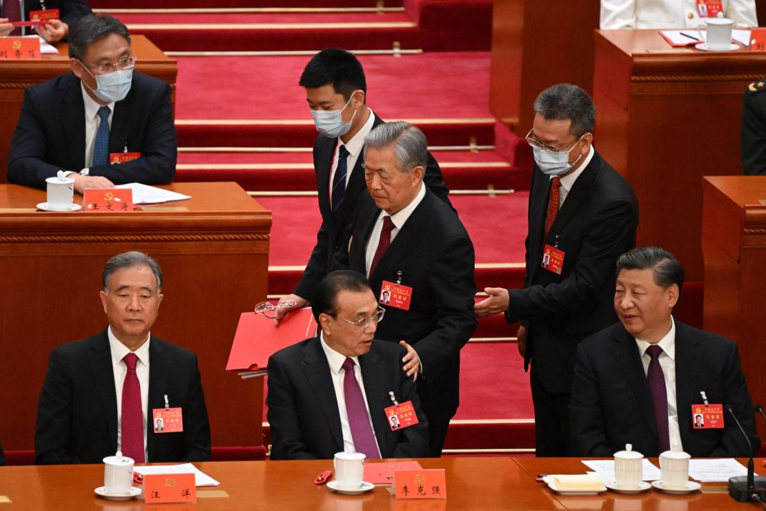 Former Chinese leader Hu Jintao pats the shoulder of his protege, Premier Li Keqiang.