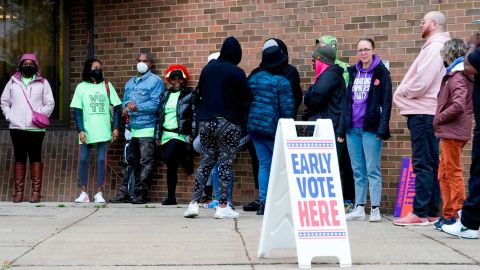 People line up outside a polling station to cast their votes Tuesday, Oct. 25, 2022, in Milwaukee.