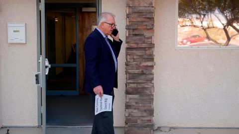 Interim Nye County Clerk Mark Kampf speaks on the phone outside of a building where early votes are being counted on October 26, 2022, in Pahrump, Nevada. 