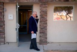 Interim Nye County Clerk Mark Kampf speaks on the phone outside of a building where early votes are being counted on October 26, 2022, in Pahrump, Nevada. 