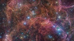 This image shows a spectacular view of the orange and pink clouds that make up what remains after the explosive death of a massive star — the Vela supernova remnant. This detailed image consists of 554 million pixels, and is a combined mosaic image of observations taken with the 268-million-pixel OmegaCAM camera at the VLT Survey Telescope, hosted at ESO's Paranal Observatory.  OmegaCAM can take images through several filters that each let the telescope see the light emitted in a distinct colour. To capture this image, four filters have been used, represented here by a combination of magenta, blue, green and red. The result is an extremely detailed and stunning view of both the gaseous filaments in the remnant and the foreground bright blue stars that add sparkle to the image.
