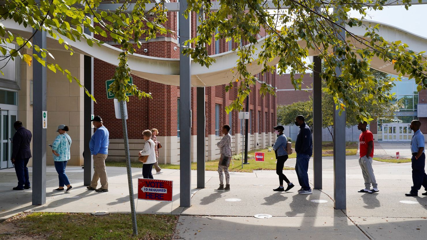 A line of early voters stretches outside the building as early voting begins for the midterm elections at the Citizens Service Center in Columbus, Georgia, October 17, 2022.  