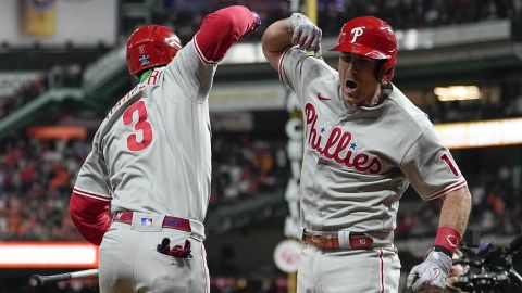 Philadelphia Phillies' J.T. Realmuto, right, celebrates his solo homer with Philadelphia Phillies' Bryce Harper during the 10th inning in Game 1 of the World Series Friday in Houston. 