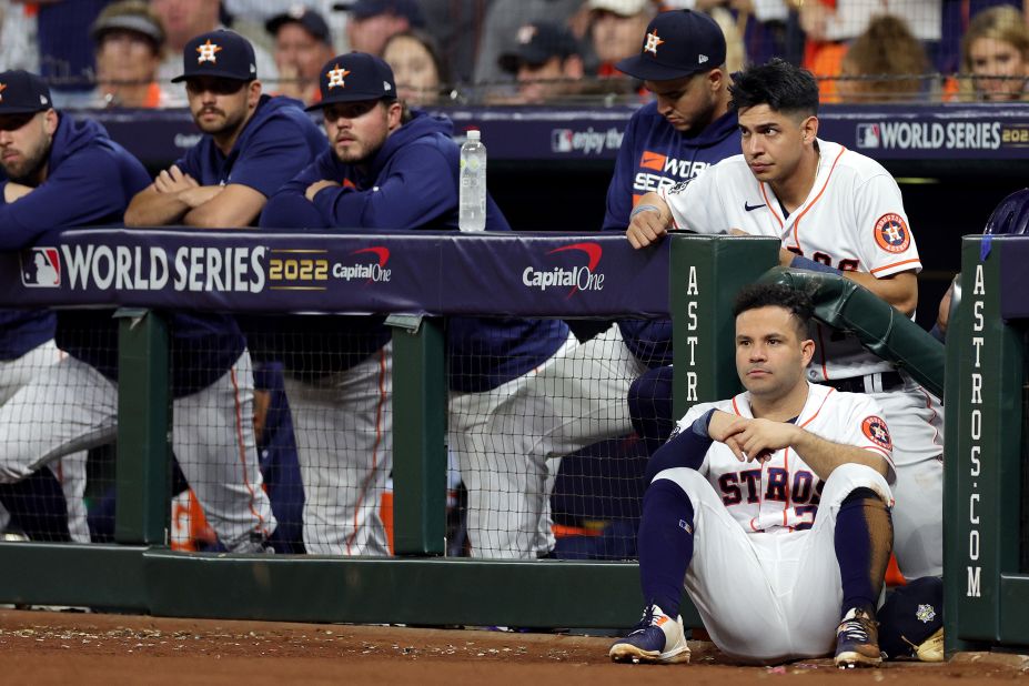 Astros watch the 10th inning from the dugout.