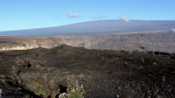 Hawaii's Mauna Loa volcano, background, towers over the summit crater of Kilauea volcano in Hawaii Volcanoes National Park on the Big Island on April 25, 2019. (AP Photo/Caleb Jones, File)