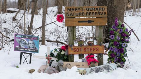Tokens sit in the snow at a memorial along the Monon High Bridge Trail in Delphi earlier this year. 
