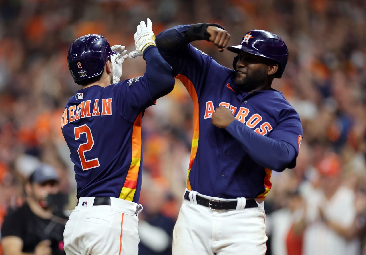 Houston's Alex Bregman and Yordan Álvarez celebrate after Bregman hit a two-run home run in Game 2 on Saturday, October 29. The fifth-inning blast gave the Astros a 5-0 lead, and they held on to win 5-2 and tie the series at one game apiece.